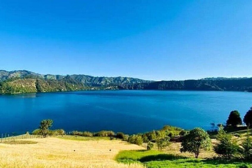 A lake surrounded by hills and trees. 3