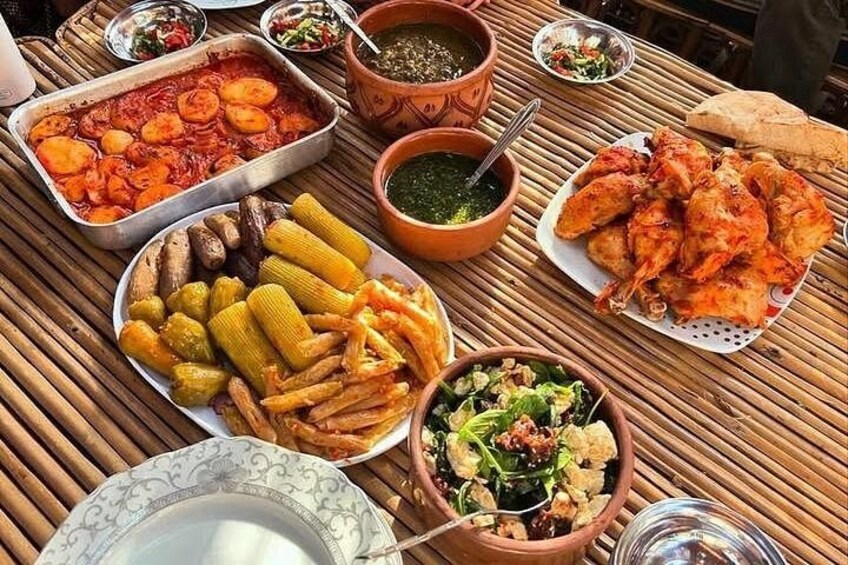 A variety of dishes including roasted chicken, corn, and a salad on a table. 4