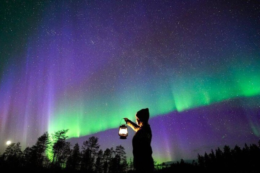 A person observing the Northern Lights with a flashlight. 2