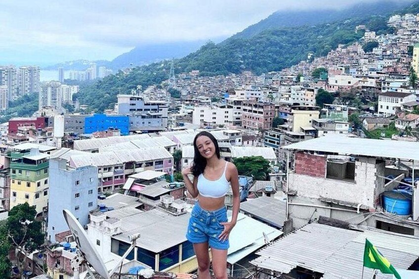 A person standing on a rooftop with a cityscape in the background. 4
