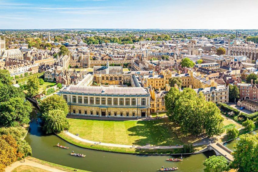 A historic university campus with a prominent building, a river, and a bridge. 3