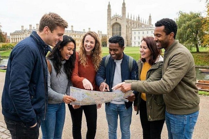 A group of people examining a map outdoors with a historic building in the background. 1