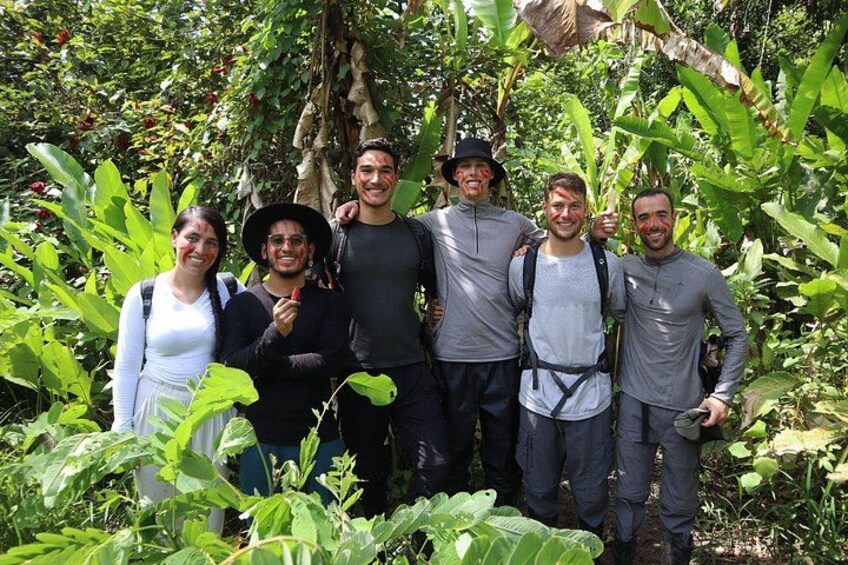 A group of people in a forested area with dense vegetation and trees. 2