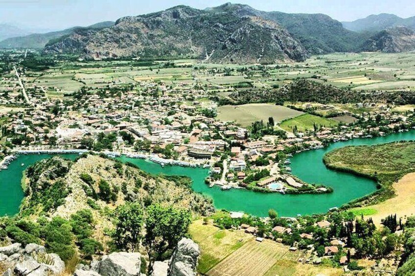 A town with a river, mountains, and fields. 1