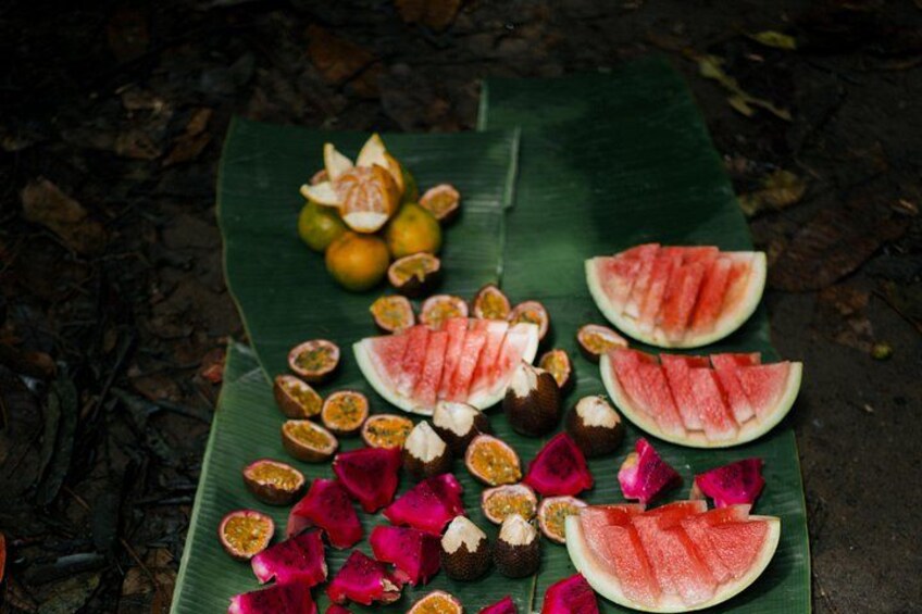 A variety of fruits and vegetables on a green leaf. 4