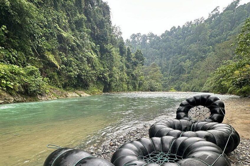 A river with inflatable tubes on the shore. 5