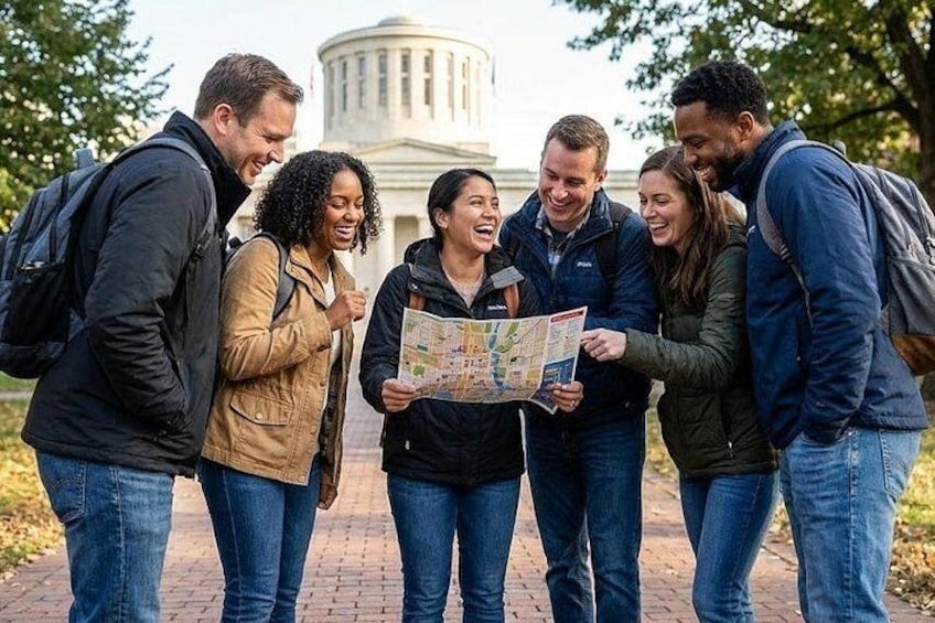 A group of people standing on a brick pathway, looking at a map. 1