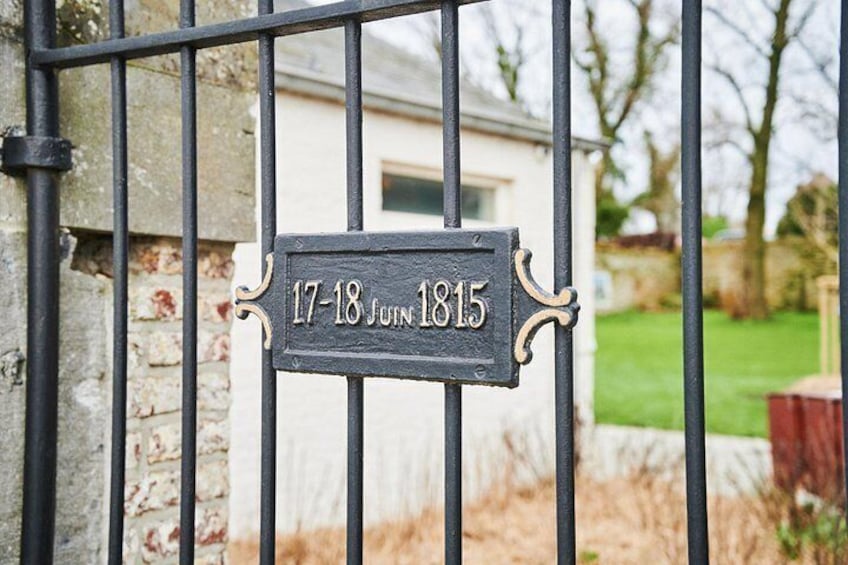 A metal gate with a sign that reads '17-18 June 1815'. 4