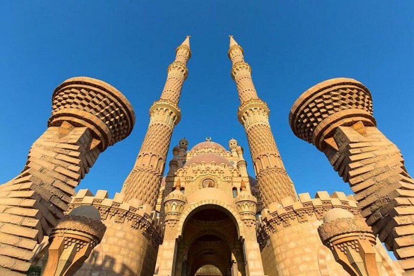 A large, ornate building with multiple minarets and domes. 1