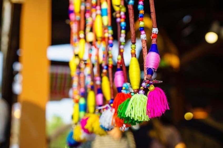 A display of colorful beaded necklaces with tassels. 5