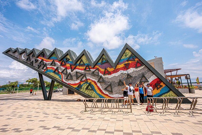 A colorful, abstract sculpture with geometric shapes and a zigzag pattern. 5