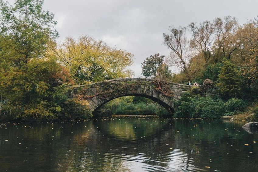 The rustic Gapstow Bridge displays reflections of the city and trees in all directions. 3