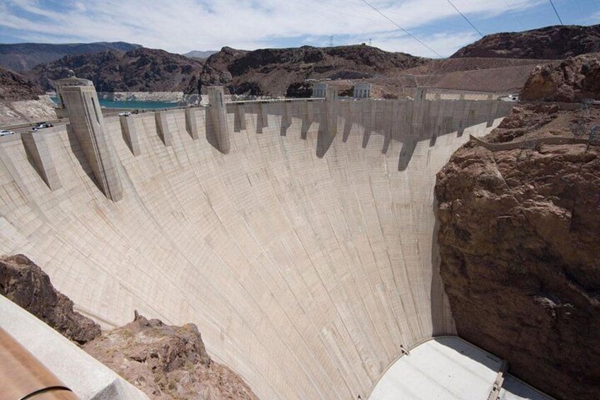 A large dam with multiple spillways and a reservoir. 3