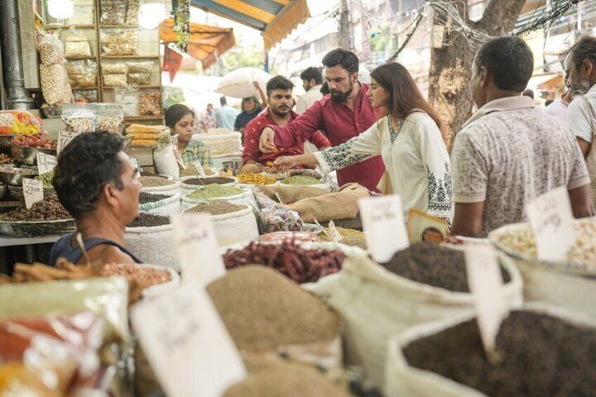 A market with people buying and selling various grains and legumes. 4
