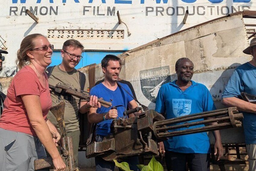 A group of people standing in front of a vehicle with a sign that reads 'RAMON FILM PRODUCTIONS.' 5
