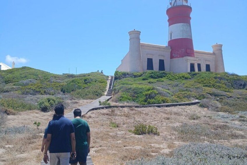 A lighthouse on a hill with a staircase leading up to it. 2
