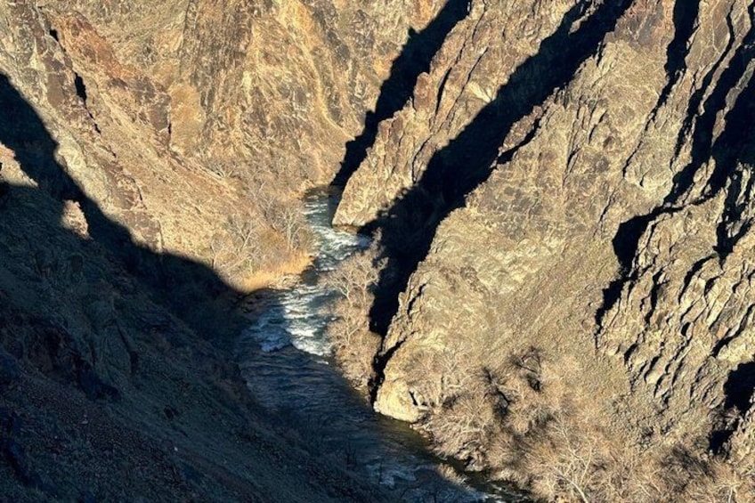 A canyon with a river flowing through it. 4