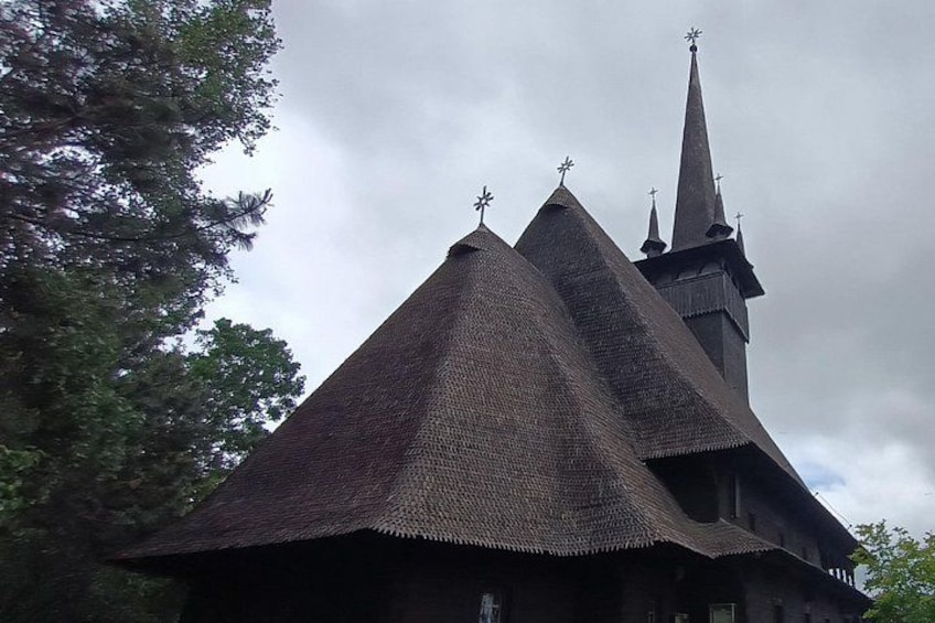A church with a steeply pitched roof and a tall spire. 3