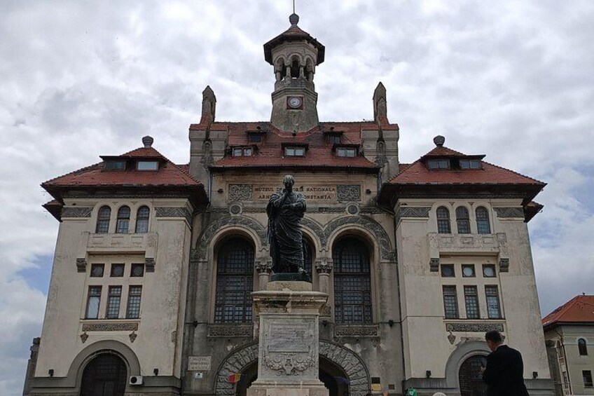 A historic building with a statue in front, a clock tower, and a sign that reads 'National Army Museum.' 4