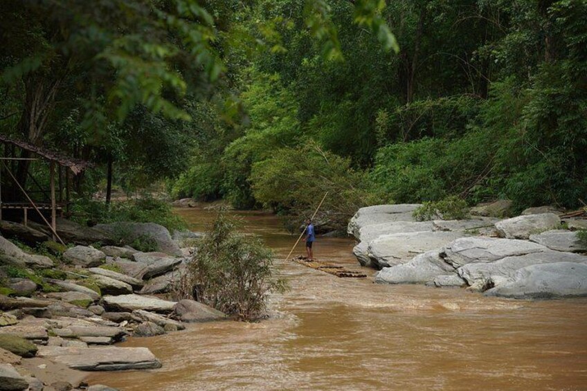 A river with rocks and a person standing in the water. 4