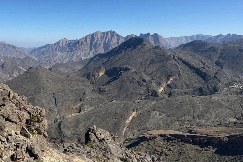 A rugged mountainous landscape with rocky terrain and a clear sky. 5