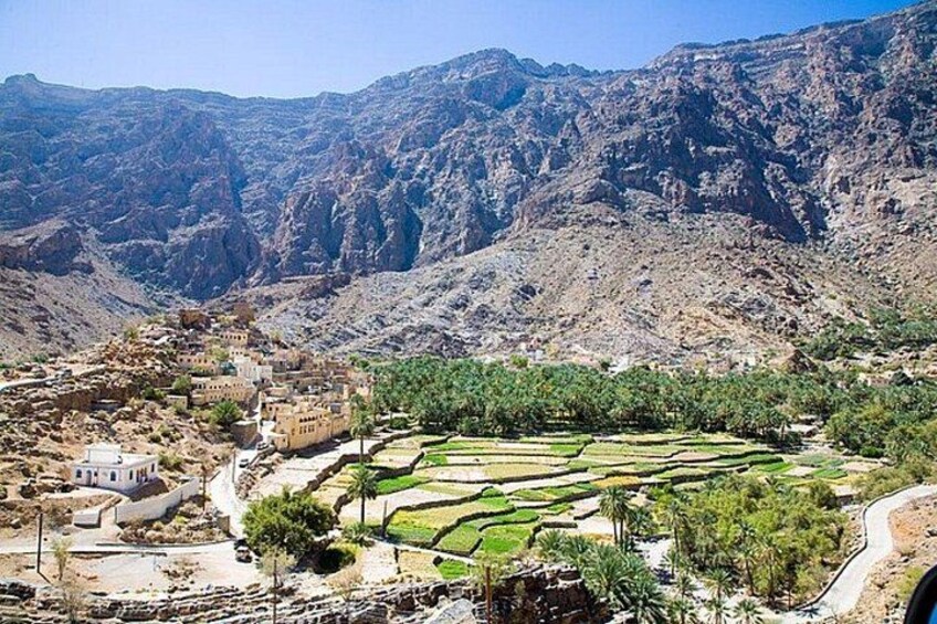 A mountainous landscape with terraced fields and traditional buildings. 4