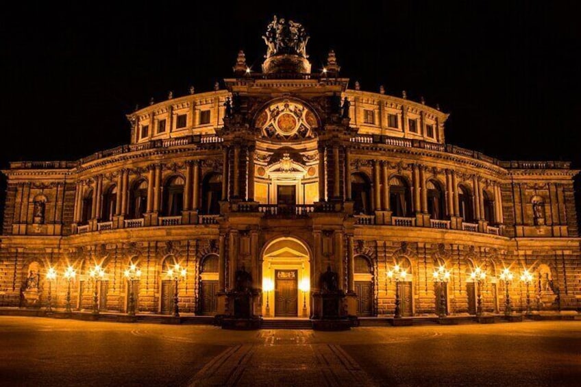 A grand, illuminated building with a central dome and multiple arches. 4