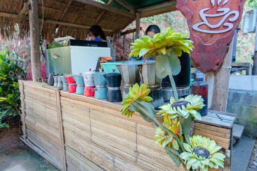 A wooden structure with potted plants and a coffee machine. 2