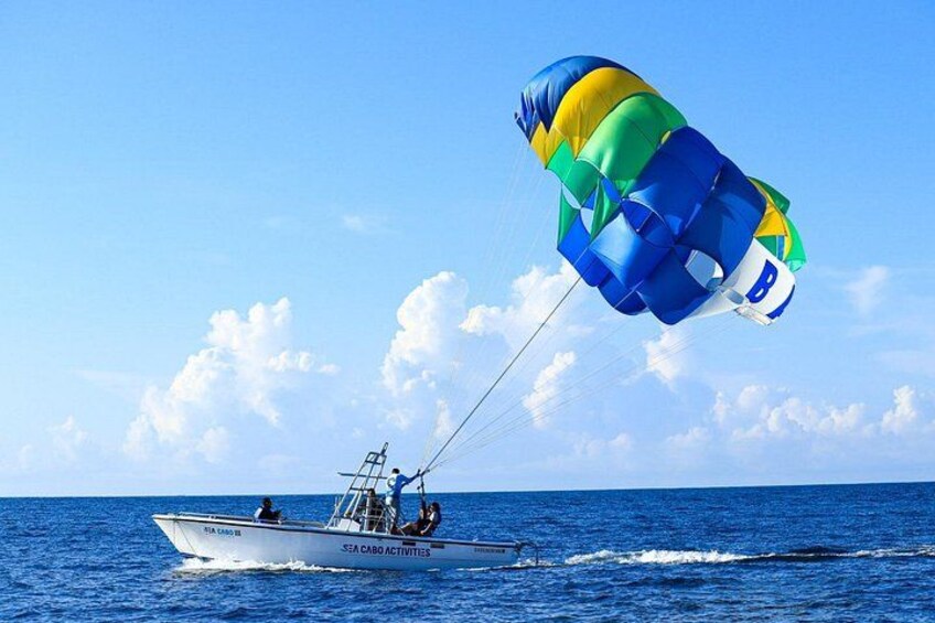 A boat with a parasail in the ocean. 3