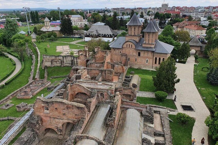 An ancient fortress with ruins, a church, and a paved walkway. 3