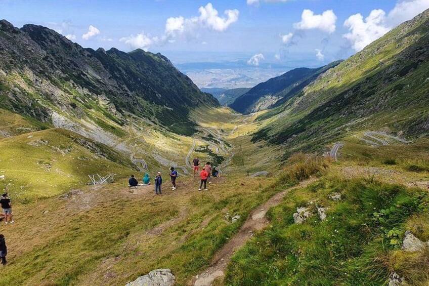 A mountainous landscape with hikers on a trail. 5