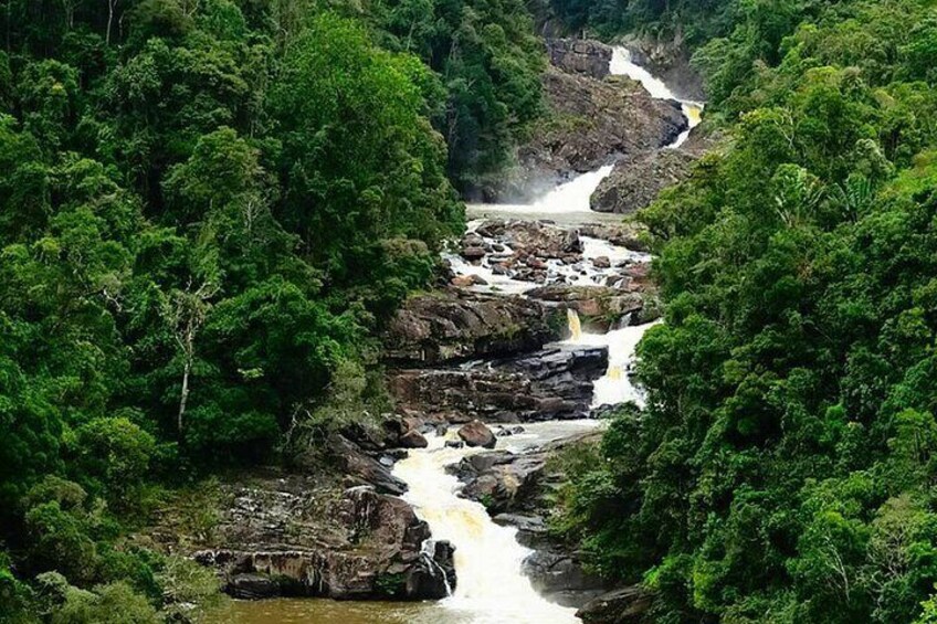 A waterfall cascading through a forested gorge. 2