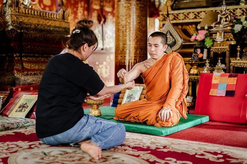 A monk offering a blessing at a local temple in Luang Prabang 2