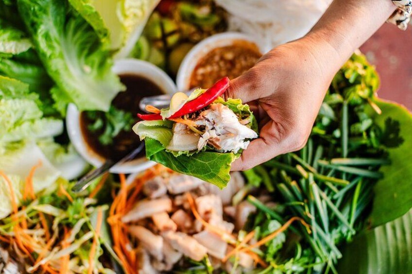 Grilled Mekong fish wrapped in crisp lettuce with herbs and dipping sauce 5