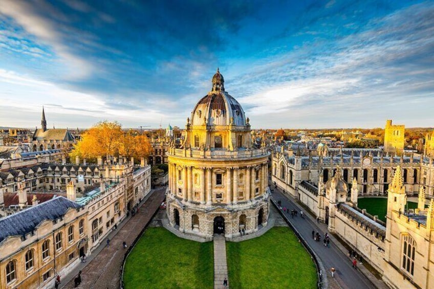 A historic building with a large dome, surrounded by a well-maintained lawn and classical architecture. 2