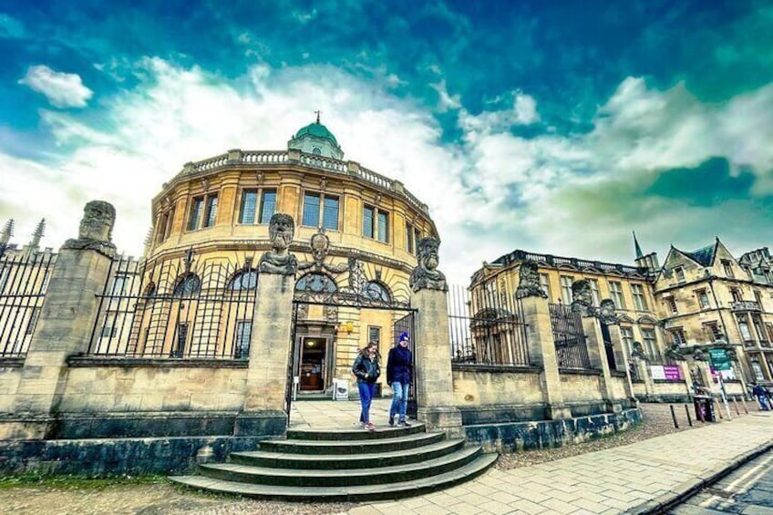 A historic building with a dome and statues, surrounded by stone walls and steps leading up to the entrance. 3