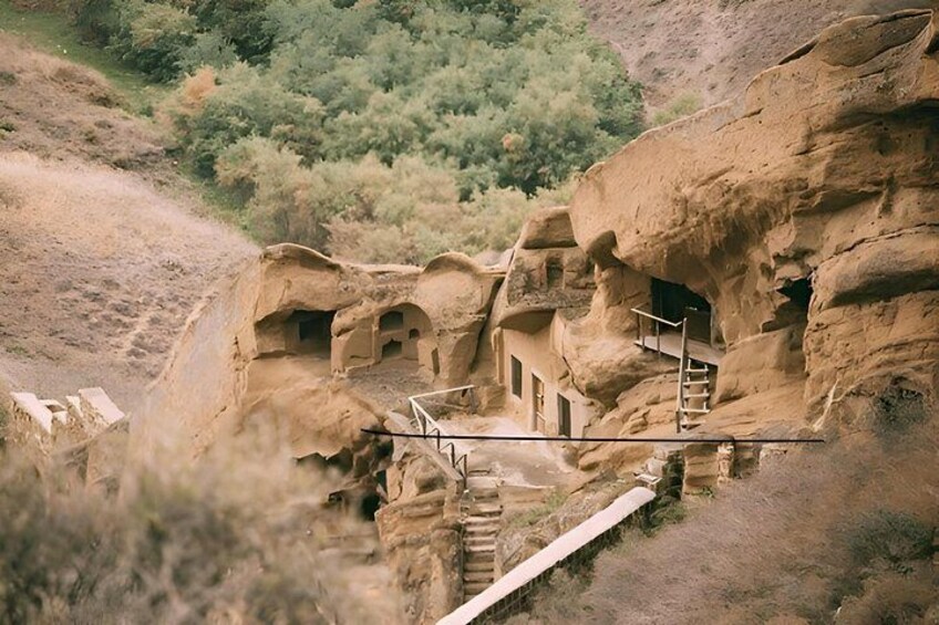 Ancient rock dwellings with staircases and pathways. 4