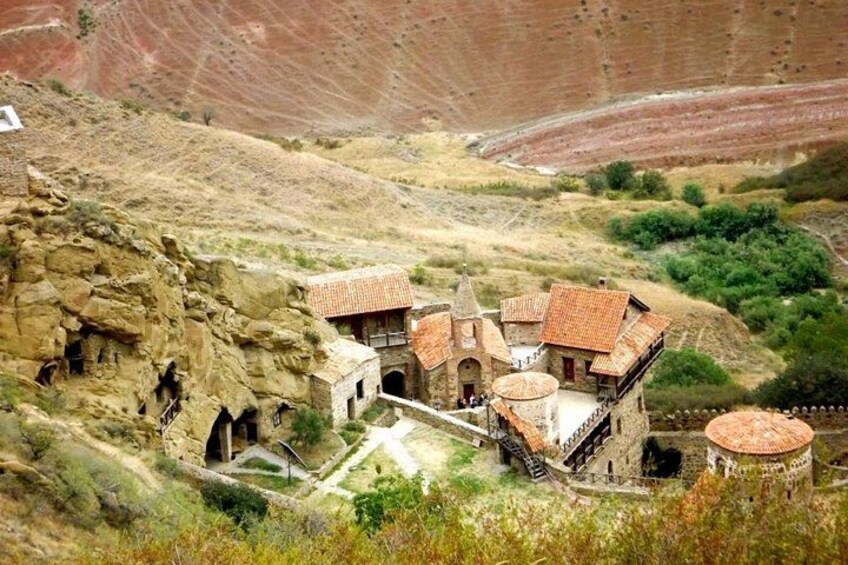 A village nestled in a rocky landscape with traditional stone buildings and terraced fields. 2