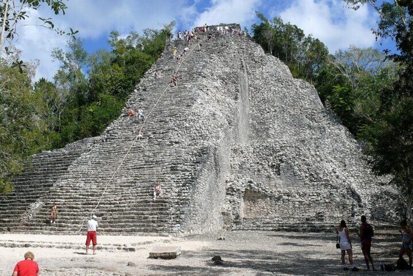 A large pyramid with people climbing its steps. 5