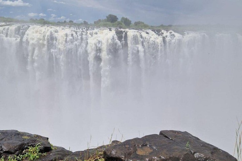 A waterfall cascading over rocks with a misty atmosphere. 5