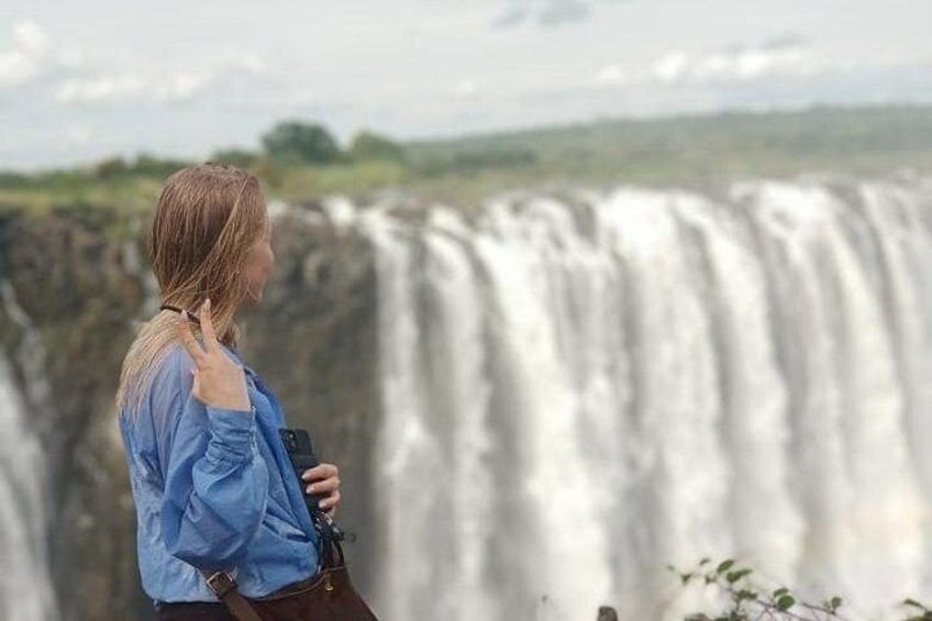 A person standing in front of a waterfall. 3