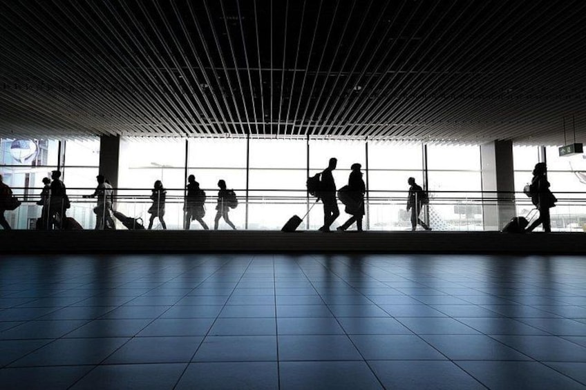 A spacious indoor area with tiled flooring and a grid-patterned ceiling. 2