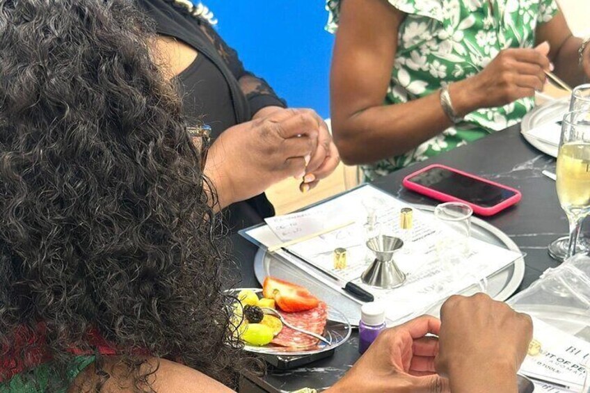 People sitting at a table with food, a phone, and documents. 5