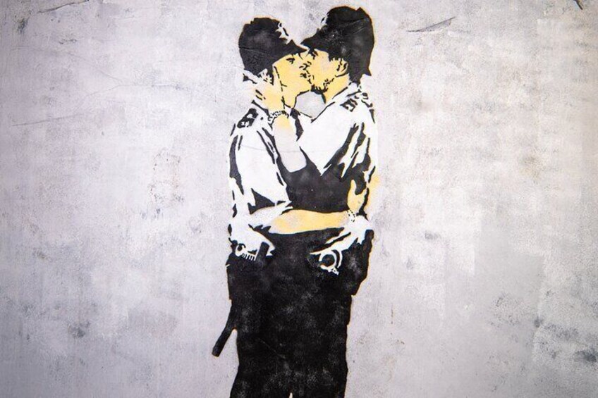 A graffiti of a couple kissing on a textured wall. 2