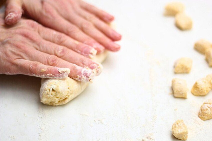 Hands kneading dough on a floured surface. 5