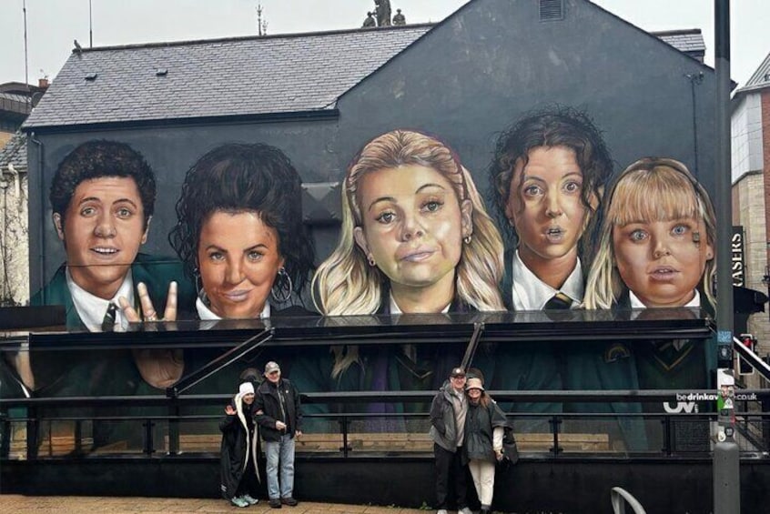 A mural of five people on a building. 4