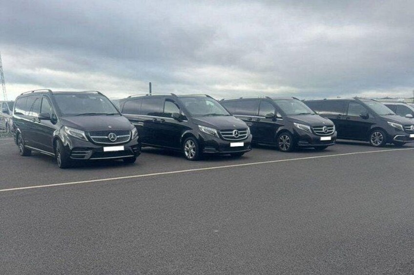 A row of parked cars in a parking lot. 2