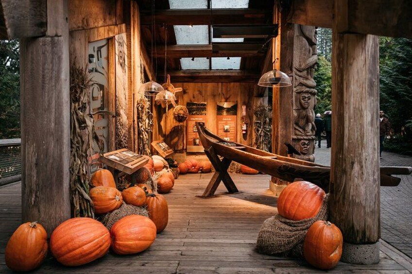 A rustic wooden structure with pumpkins and a canoe. 3
