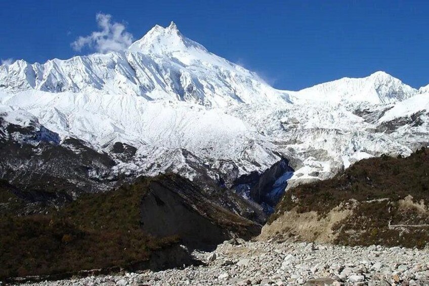 A snow-covered mountain range with a glacier. 1