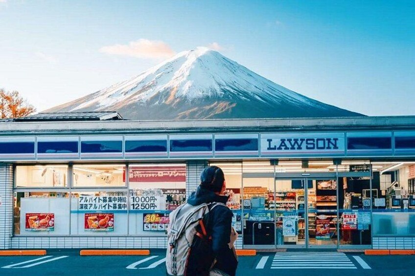 A Lawson convenience store with a mountain in the background. 1